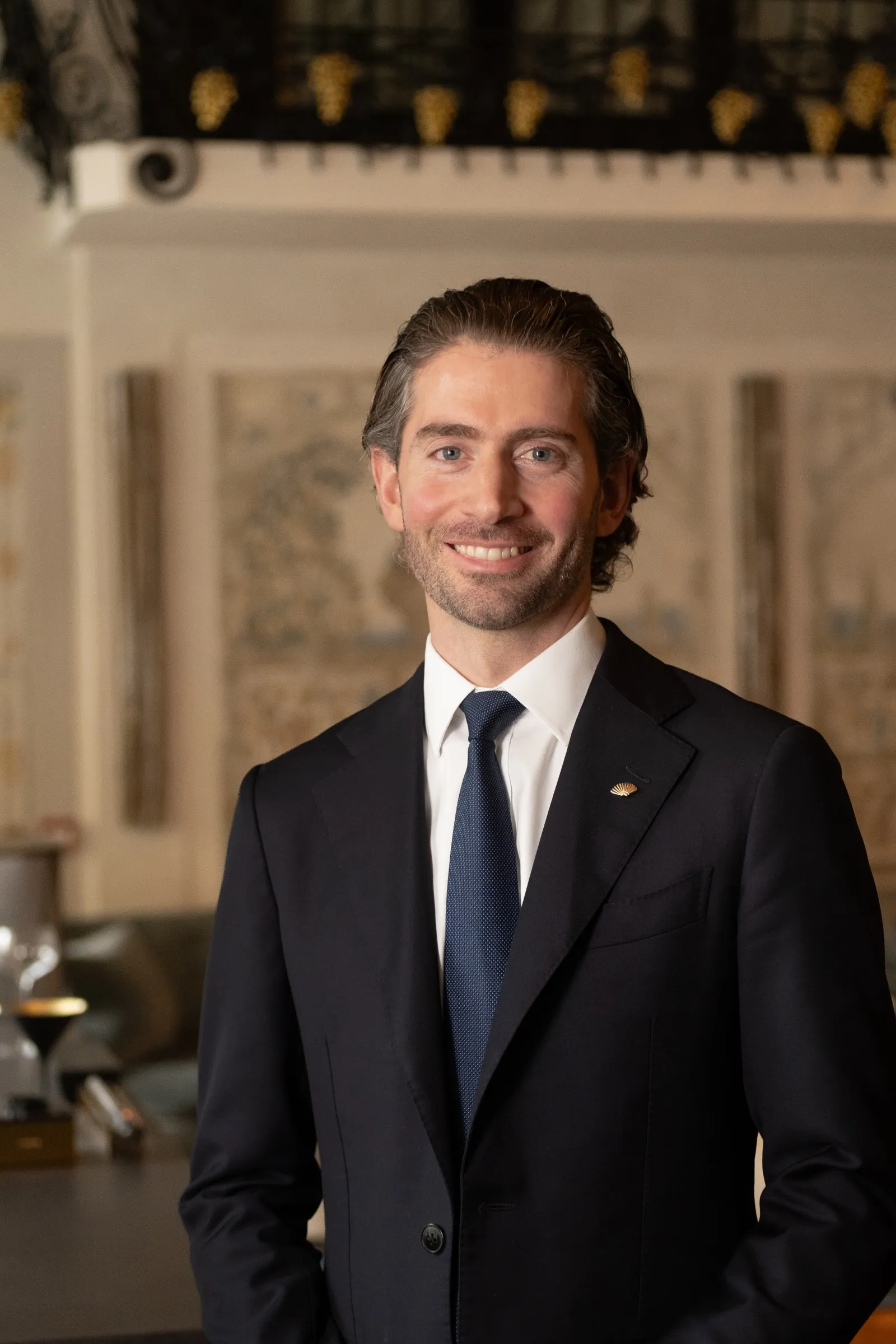Portrait of a smiling man in a dark suit and tie